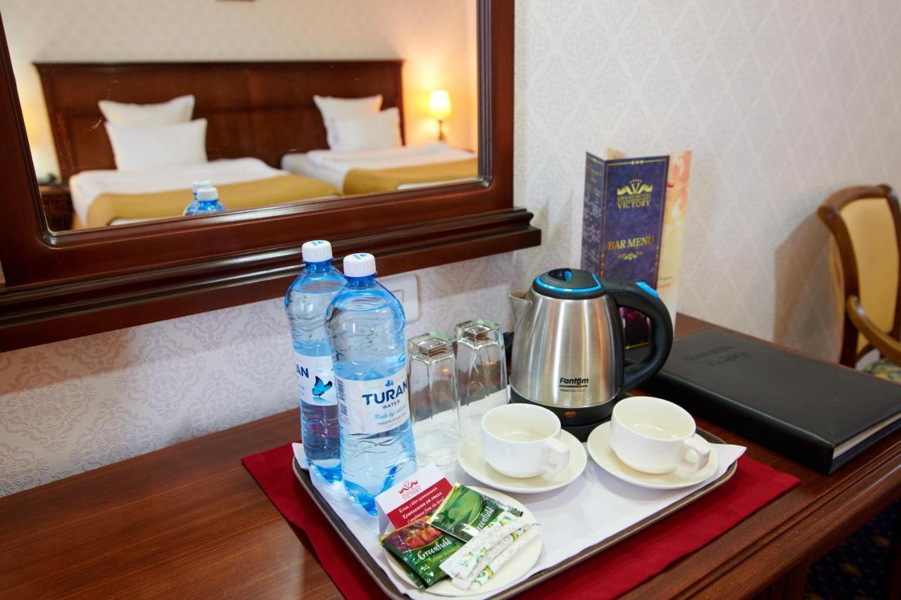 Grand Hotel Victory Aktau  Exterior photo A kettle in a hotel room
