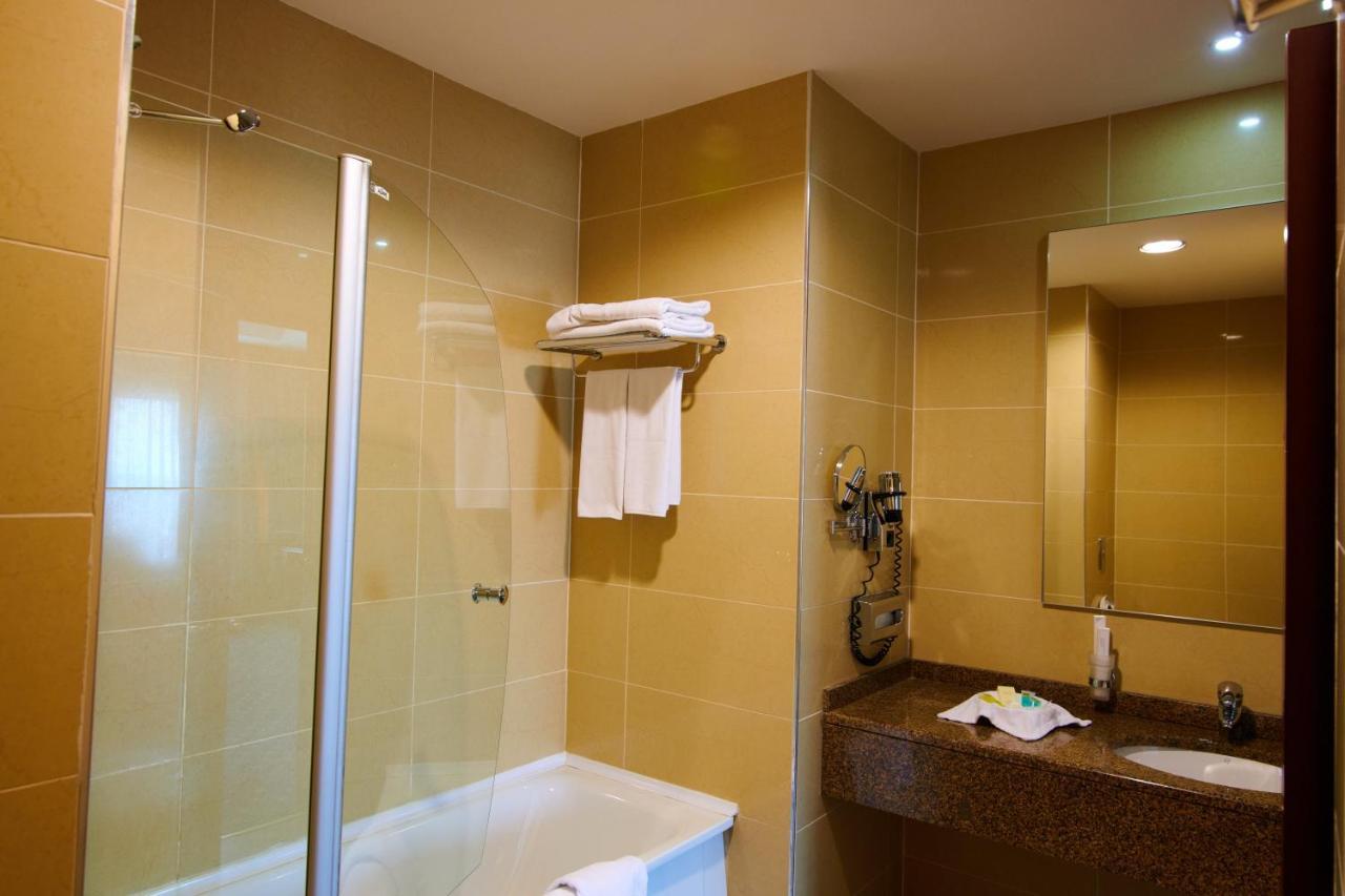 Grand Hotel Victory Aktau  Exterior photo A shower door